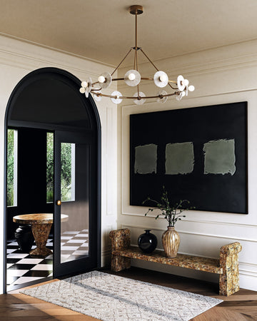 Alora Dahlia chandelier in vintage brass with decorative glass discs in a transitional entryway