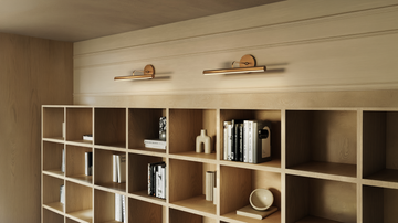 Modern interior featuring Kuzco Slender brass wall sconces mounted over wooden grid shelving in a blog feature banner titled 'Guide to Modern Home Lighting: Art & Accent Sconces'.